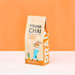 Prana Chai packaging on an orange background