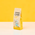 Prana Chai turmeric blend package on a yellow background