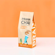 Prana Chai packaging on an orange background