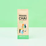 Prana Chai vegan blend package on a light green background