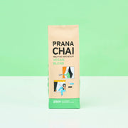 Prana Chai vegan blend package on a light green background