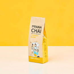 Prana Chai turmeric blend package on a yellow background