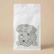 White coffee bag with a black line drawing of a dog's face on a beige background