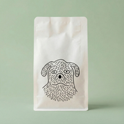White coffee bag with a black dog illustration on a light green background